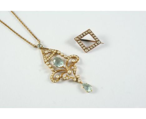 AN EDWARDIAN AQUAMARINE AND PEARL SET PENDANT the 15ct gold openwork scrolling mount centred with an oval-shaped aquamarine, 