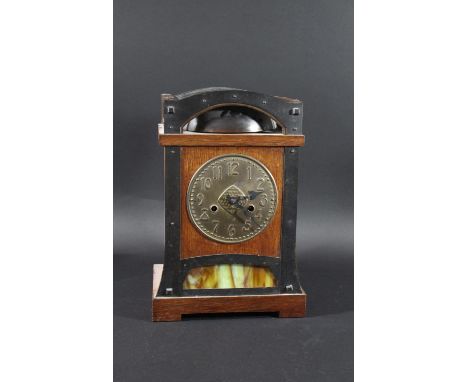 ARTS &amp; CRAFTS GERMAN MANTLE CLOCK an oak and metal clock with metal dial, the arched top enclosing a large bell. The bott