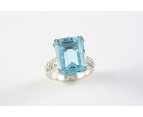 AN BLUE TOPAZ AND DIAMOND CLUSTER RING the step-cut blue topaz is set with three rows of circular-cut diamonds to each should