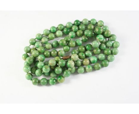 A SINGLE ROW UNIFORM JADE BEAD NECKLACE the jade beads measure approximately 9.7mm, 112cm long