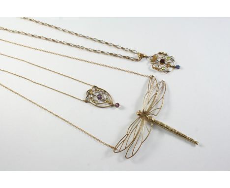 AN EDWARDIAN AMETHYST AND SEED PEARL PENDANT the openwork foliate mount set with two circular-cut amethysts and seed pearls, 