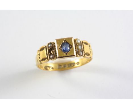 A VICTORIAN SAPPHIRE AND PEARL SET RING the 15ct gold mount is centred with an oval-shaped sapphire, with seed pearls (one mi