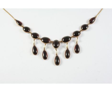 A GARNET AND GOLD DROP NECKLACE the gold chain necklace mounted with oval and pear-shaped collet set garnets, suspending pear