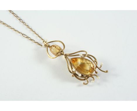 A GOLD, CITRINE AND CULTURED PEARL PENDANT the gold openwork scrolling mount set with an oval-shaped citrine and a pear-shape