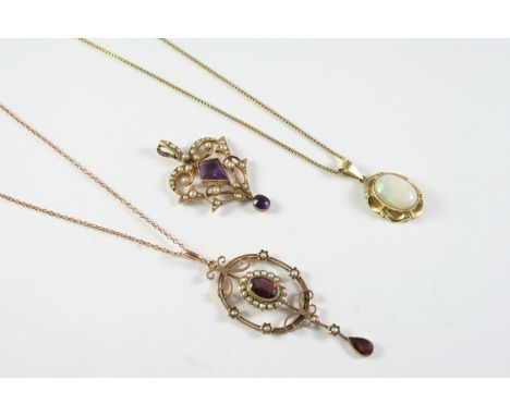 AN EDWARDIAN AMETHYST AND PEARL SET PENDANT the gold openwork mount is centred with a kite-shaped amethyst, suspends an oval 