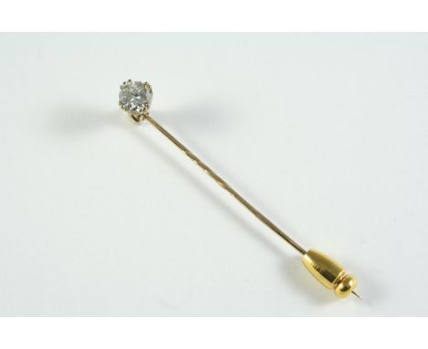 A DIAMOND STICK PIN mounted with a brilliant-cut diamond, in gold