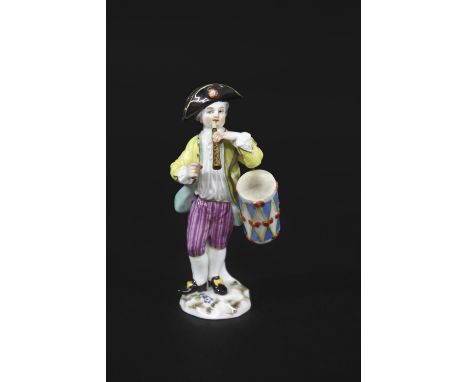 MEISSEN DRUMMER BOY a small figure of a Drummer Boy, brightly painted and playing an instrument. Mounted on a floral encruste