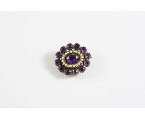 A GEORGIAN AMETHYST AND PEARL BROOCH the oval shaped brooch is mounted with an oval amethyst within a surround of circular-cu