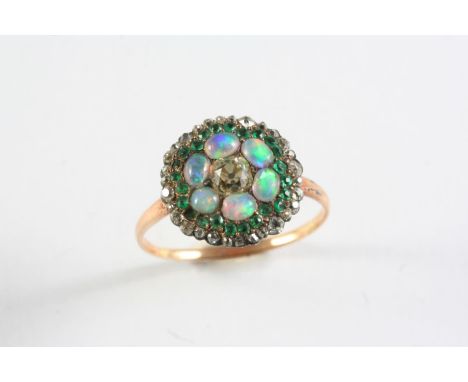 A 19TH CENTURY DIAMOND, EMERALD AND OPAL CLUSTER RING the central cushion-shaped diamond set within surrounds of oval-shaped 