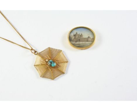 A 9CT GOLD SPIDER'S WEB PENDANT the spider mounted with a turquoise cabochon and a small pearl, 3.5cm wide, 6.1 grams, togeth