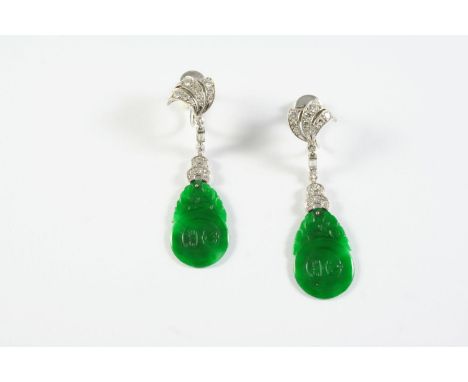 A PAIR OF JADE AND DIAMOND DROP EARRINGS each earring formed with scroll design mount set with a baguette-cut diamond and ove