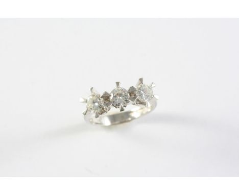 A DIAMOND THREE STONE RING the three brilliant-cut diamonds are set in 18ct white gold. Size K 1/2