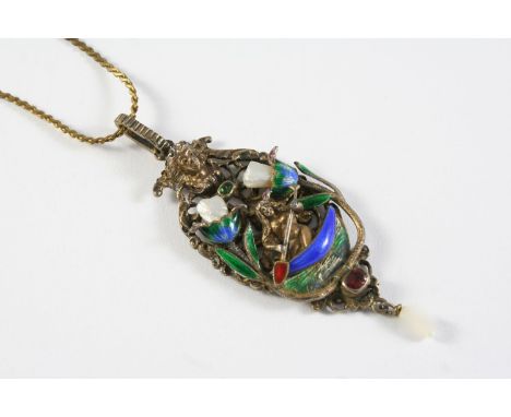 AN ENAMEL AND SILVER GILT PENDANT depicting a woman in a canoe amongst foliage, with enamel, gem set and pearl decoration, 7c
