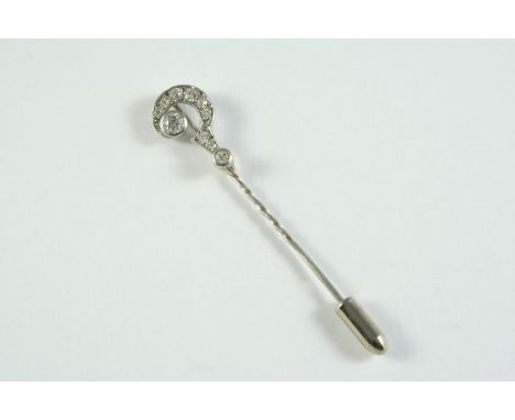 A DIAMOND QUESTION MARK STICK PIN mounted with two collet set old circular-cut diamonds and millegrain set with graduated cir