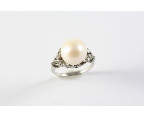 A CULTURED PEARL AND DIAMOND RING the cultured pearl measuring approximately 11.0mm, in a scrolling openwork mount set with g