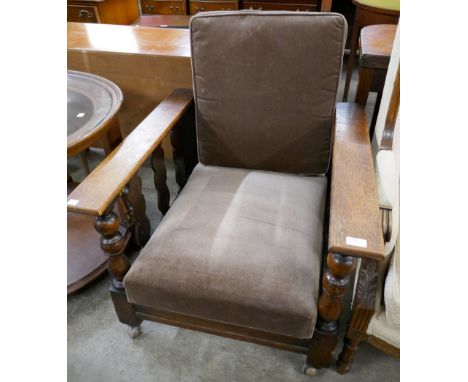 An early 20th Century Ercol oak reclining armchair 