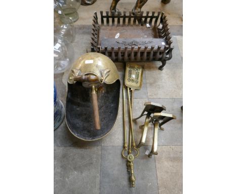 A Victorian brass coal scuttle, a cast iron fire grate and brass companion set 