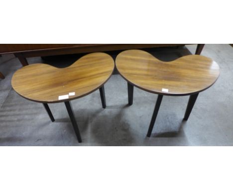A pair of tola wood and black kidney shaped lamp tables 