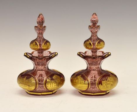 Pair of 19th Century Bohemian ruby and clear glass double scent bottles, each having four gilt reserves typically decorated w