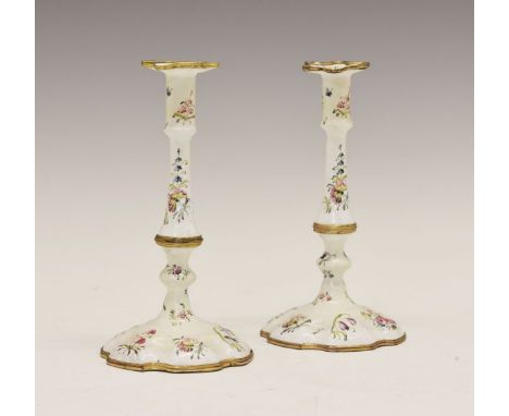 Pair of late 18th Century Battersea enamel candlesticks, each typically decorated with floral sprays on a white ground, 16.5c