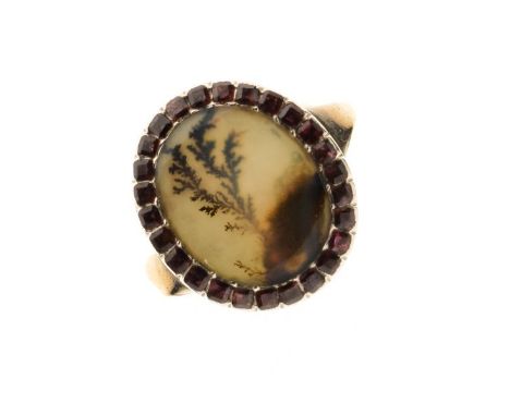 Georgian garnet and moss agate ring, circa 1800, the oval agate panel enclosed by flat cut stones, size O, 2.6g gross  Condit