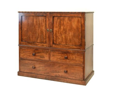 Early 19th Century mahogany low linen press cupboard or 'half dresser', the oblong top with reel carving over a pair of field