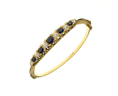 18ct gold diamond and sapphire hinged bangle, 1974, the five graduated round cut sapphires with six brilliant cut diamonds, t