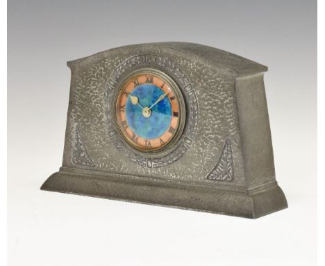 Liberty & Co Tudric hammered pewter cased mantel clock having stylised foliate decoration in low relief, the circular dial wi