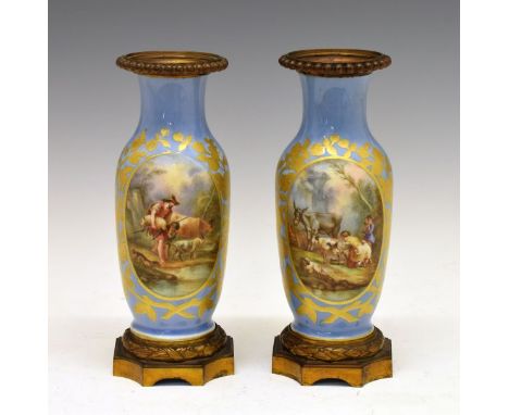 Pair of 19th Century porcelain vases, probably French, each having a painted reserve depicting country folk with animals with