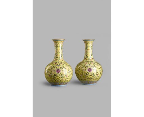 A PAIR OF CHINESE FAMILLE ROSE BOTTLE VASES, 19TH CENTURY Each decorated with a stylized lotus scroll, with peaches, flowers 
