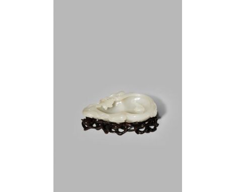 A CHINESE WHITE JADE BRUSH WASHER, QING DYNASTY OR LATER Shaped as a large gourd issuing from a gnarled stem with smaller gou