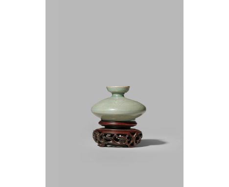 A SMALL KOREAN CELADON GLAZED OIL BOTTLE OR JAR, 12TH-13TH CENTURY  Of compressed circular form with an everted rim, the body