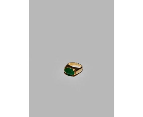 A BURMESE 'IMPERIAL' JADEITE AND GOLD RING, 20TH CENTURY With a cabochon-cut stone set in a plain gold mount, a single punch 