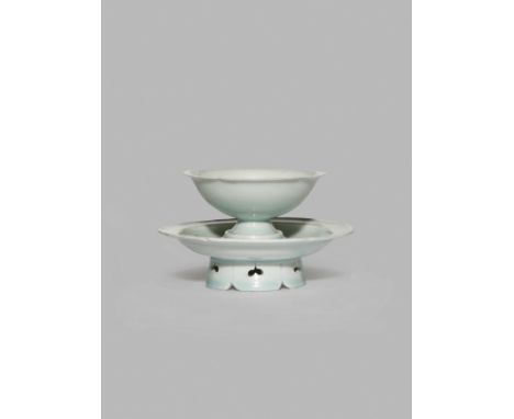 A CHINESE QINGBAI CUP AND STAND, SONG DYNASTY 960-1279 AD The lobed U-shaped cup raised on a short flared foot, the stand wit