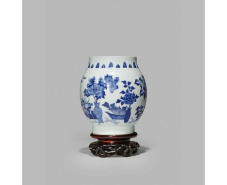 A CHINESE BLUE AND WHITE OVOID VASE, C.1640 Painted with vases and jardinières containing arrangements of peony, rose and lot