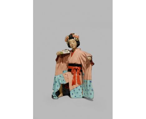 A JAPANESE CERAMIC EROTIC MODEL OF A DANCER, MEIJI 1868-1912 Kneeling with her arms outstretched, her long sleeves hanging be