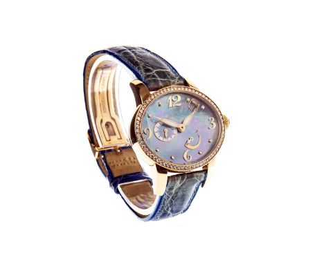 LADY'S RARE GIRARD-PERREGAUX CATS EYE EIGHTEEN CARAT GOLD AUTOMATIC WRIST WATCH, the oval blue tone mother of pearl dial with