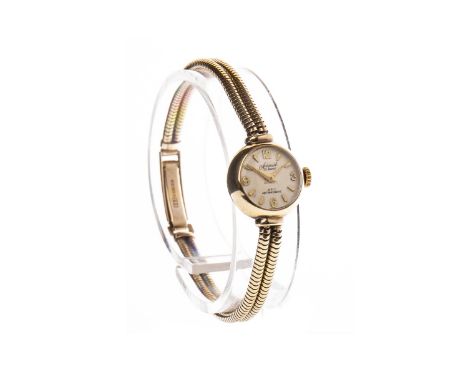 LADY'S ACCURIST GOLD MANUAL WIND WRIST WATCH, the round dial with applied Arabic and wedge hour markers, gold sword hands, 14