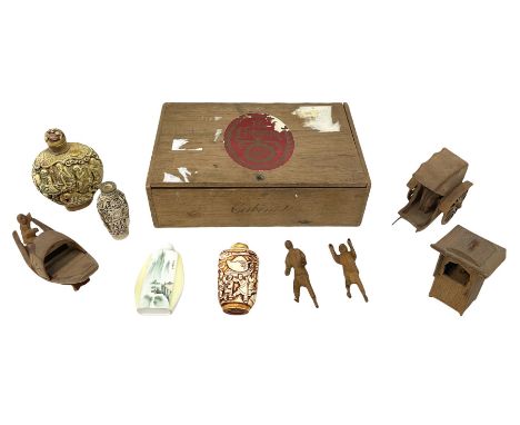 Three oriental carved bone snuff bottles, a further ceramic example, along with carved wood oriental figures, housed in hinge