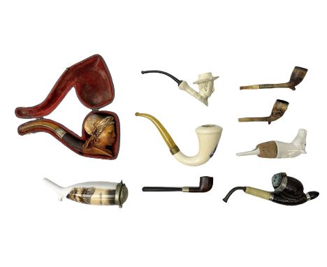 Carved meerschaum and amber pipe with silver mount, the bowl carved as a woman, cased, clay pipe in the form of an acorn, cer
