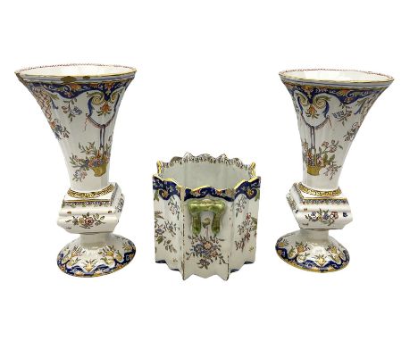 Two French faience polychrome vases and twin handled planter, all decorated with yellow baskets of flowers hanging from ribbo