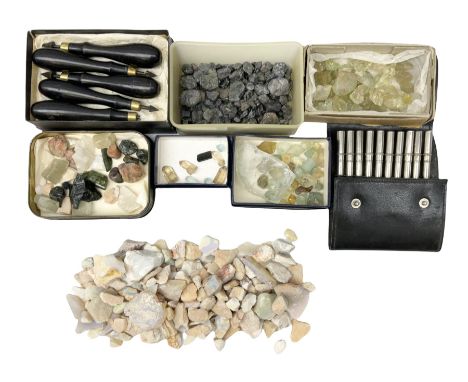 Collection of loose uncut stones including star sapphire, green amethyst, opal, topaz and moonstone and two sets of tools