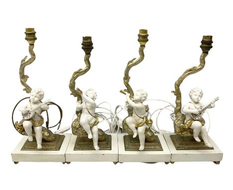 Pair of gilt and ceramic table lamps depicting putti sitting upon a tree playing a horn, together with a pair of similar tabl