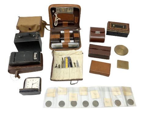 Gents leather cased travelling toilet set and cased brushes; two cameras; roll of drawing instruments; travel clock; coins; c