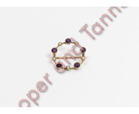A garnet and seed pearl circlet brooch, tagged '15ct', 2.1 cm diameter, 2.2 g gross