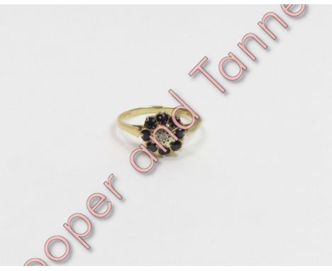 An 18 carat gold diamond and sapphire cluster ring, finger size Q, 3g gross, cased