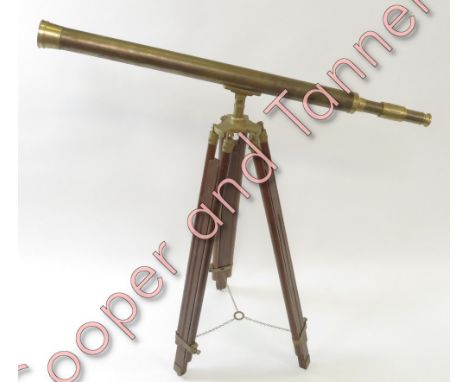 A reproduction telescope on tripod stand, having brass barrel, 6.5cms diam