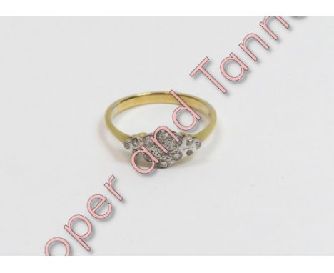 A diamond cluster ring, stamped '18ct', set with thirteen single cuts, finger size K, 2.3 g gross, cased
