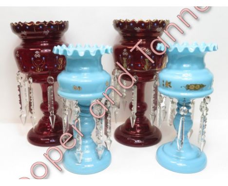 A pair of 19th Century ruby glass lustres with painted decoration 31cms high together with a pair of turquoise glass lustres 