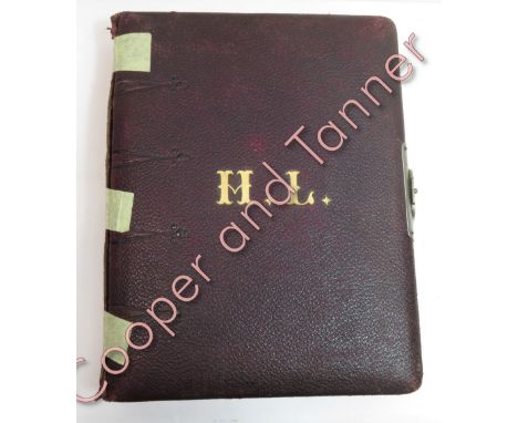 A late Victorian leather bound photograph album, alternate pages with coloured lithographic Naval themed decoration and conta